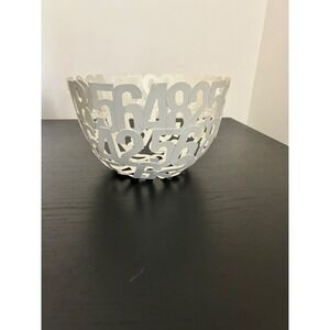 contemporary centerpiece bowl made of off-white metal, featuring a design number